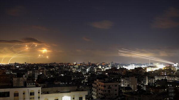 Rockets fired from the Gaza City (R) being intercepted by Israel's Iron Dome defence missile system (L) on October 10, 2023.  - Sputnik Türkiye