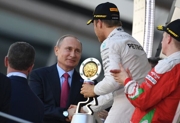 Formula 1 Soçi Grand Prix'inde gerçekleşen yarışın birincisi Nico Rosberd ödülünü Rusya Devlet Başkanı Vladimir Putin'den aldı. - Sputnik Türkiye