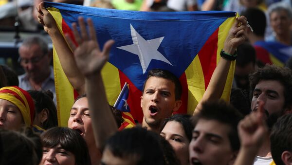Eylemciler 'Oy kullanacağız', 'Merhaba demokrasi' sloganları atıp, 'Diktatörlüğü durdurun' pankartı taşıdı. Katalonya'nın bağımsızlığını savunan sivil toplum örgütleri İspanyol jandarmasının dün gerçekleştirdiği gözaltılar ve Katalan resmi kurumlarında yaptığı aramalara karşı uzun süreli protesto gösterileri düzenlenmesi çağrısında bulunmuştu. - Sputnik Türkiye