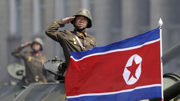 In this Saturday, April 15, 2017, file photo, a North Korean national flag flutters as soldiers in tanks salute to North Korean leader Kim Jong Un during a military parade in Pyongyang, North Korea to celebrate the 105th birth anniversary of Kim Il Sung, the country's late founder and grandfather of the current ruler - Sputnik Türkiye