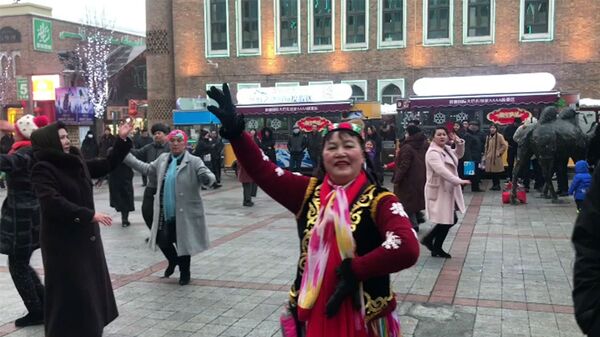 Sincan Uygur Özerk Bölgesi'nin başkenti Urumçi'de geleneksel dans gösterisi yapan bir grup - Sputnik Türkiye
