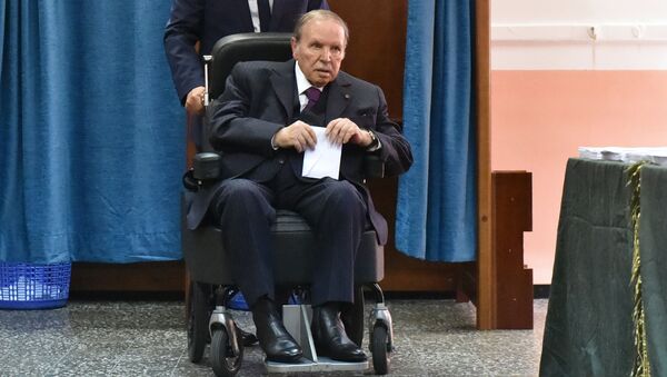 (FILES) In this file photo taken on May 04, 2017 Algerian President Abdelaziz Bouteflika is seen on a wheelchair as he votes at a polling station in Algiers. - Sputnik Türkiye