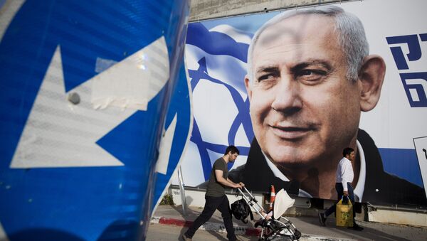 A man walks by an election campaign billboard showing Israel's Prime Minister Benjamin Netanyahu, the Likud party leader, in Tel Aviv, Israel, Sunday, April 7, 2019 - Sputnik Türkiye